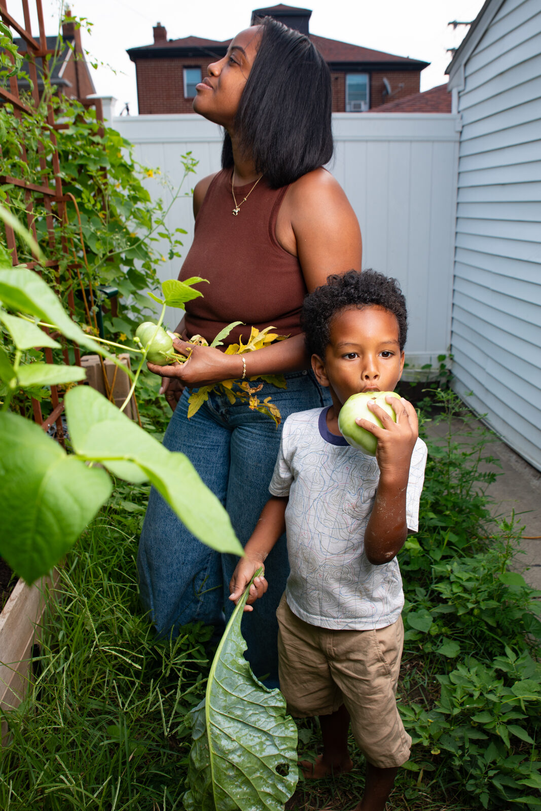 A mother and son picking vegetables together